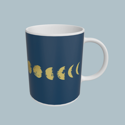 Navy blue mug with yellow moon phases on a light gray background