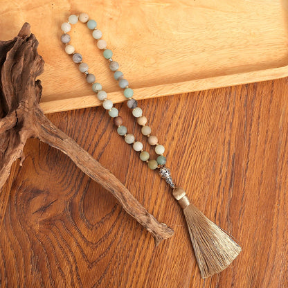 33-bead Amazonite tasbih beside driftwood piece