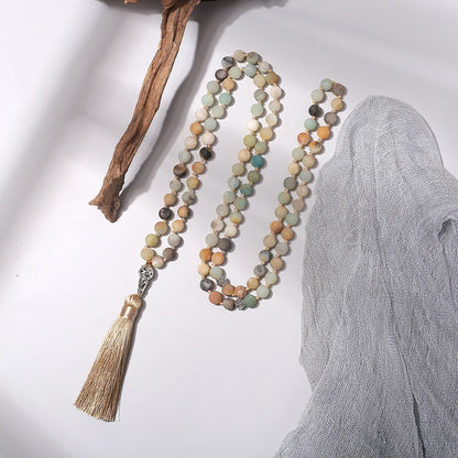 99-bead Amazonite tasbih beside driftwood