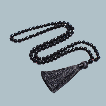 99-bead Black Onyx tasbih elegantly laid out, showcasing deep black tones