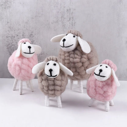 Small grey and pink, medium pink, and large grey sheep arranged for Eid display