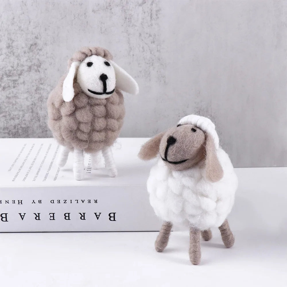 Small grey and medium white wool felt sheep on soft neutral backdrop