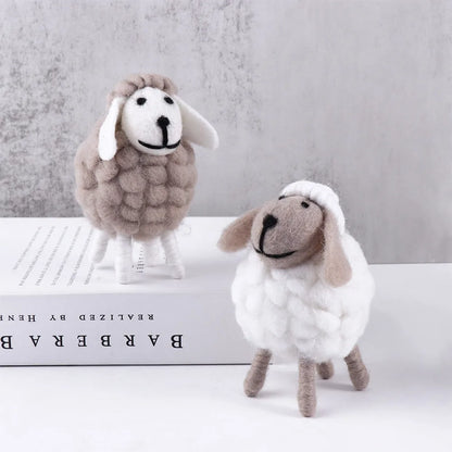 Small grey and medium white wool felt sheep on soft neutral backdrop