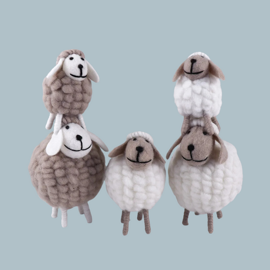 Group display of white and grey felt sheep for Eid table decoration