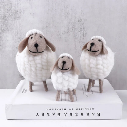 White wool felt sheep in small, medium, and large sizes grouped together