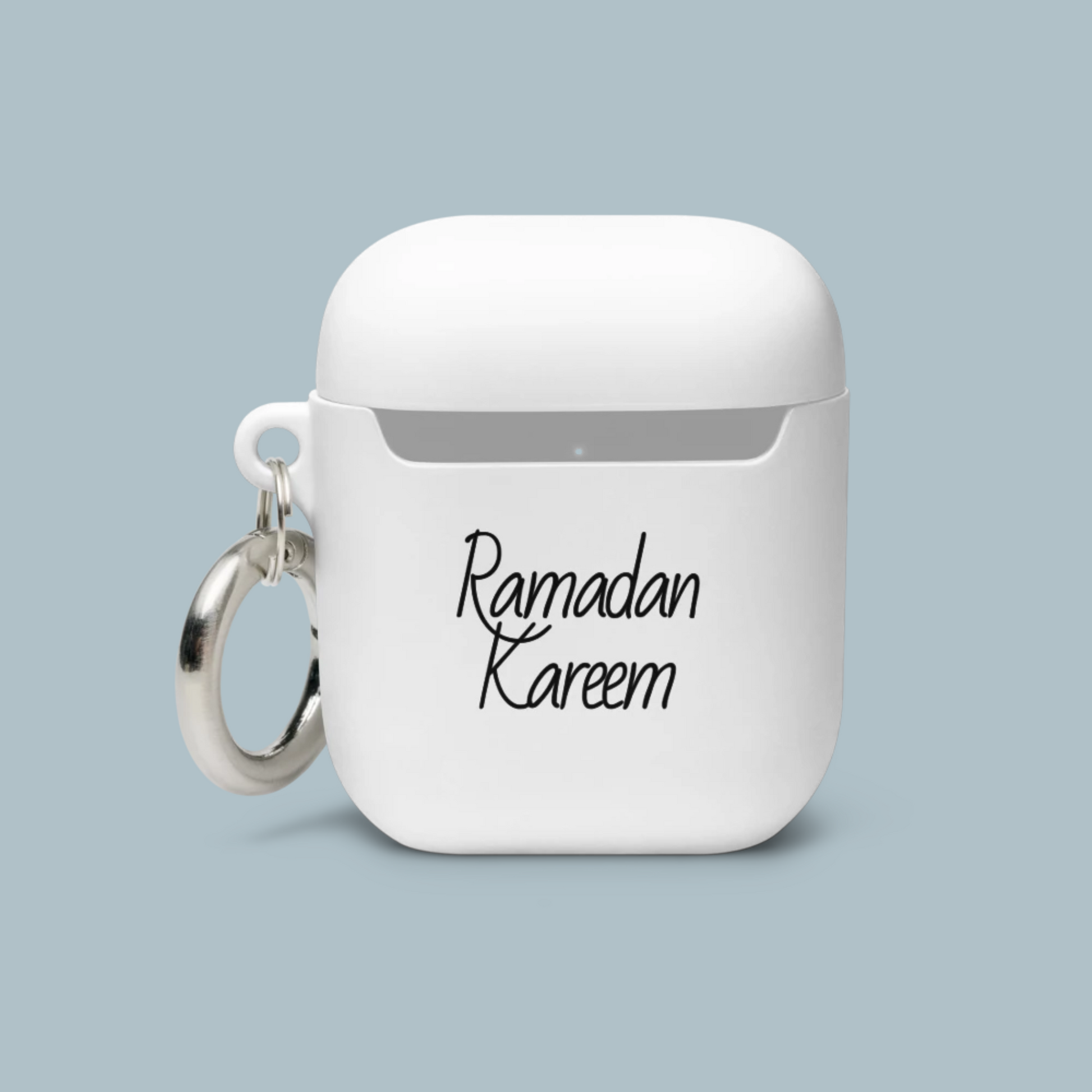 White airpod case with 'Ramadan Kareem' text on a light blue background