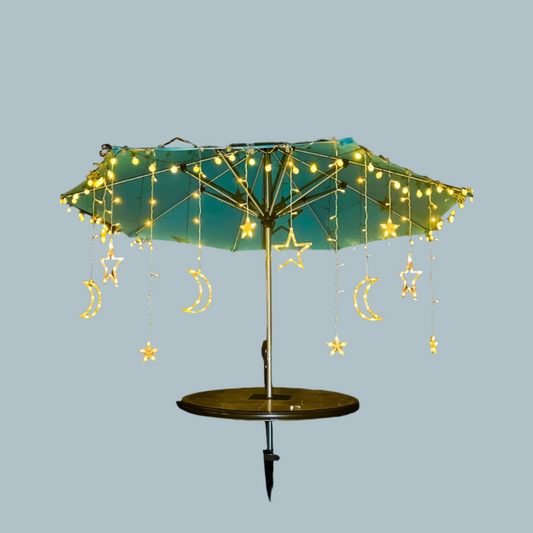 Moon and star LED curtain lights hanging on an outside umbrella 