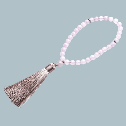 33-bead Rose Quartz tasbih in soft pink tones on display