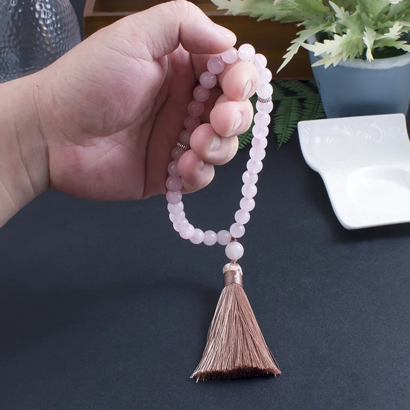 33-bead Rose Quartz tasbih gently held in hand, displaying bead clarity