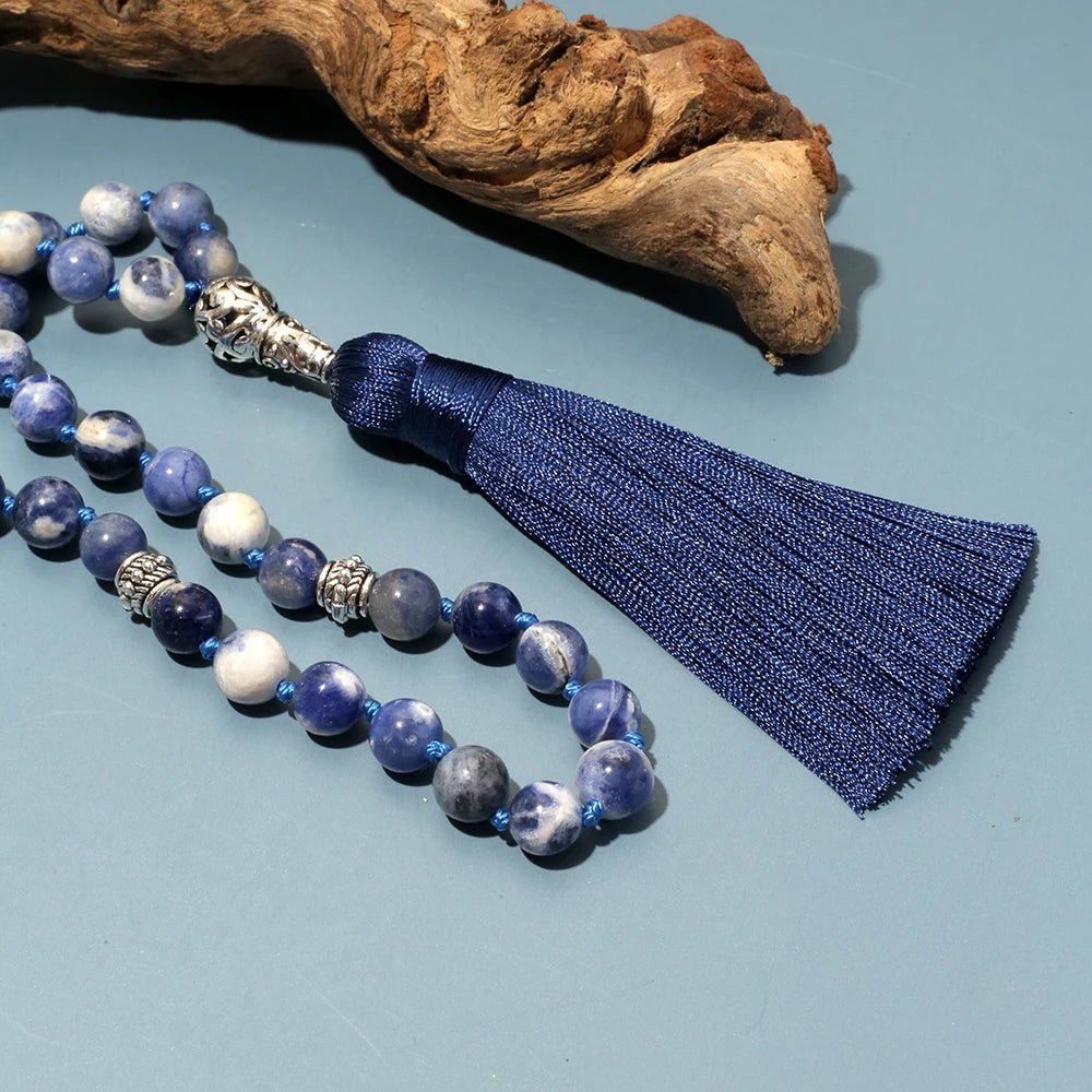 Zoomed image of Sodalite beads with driftwood in background