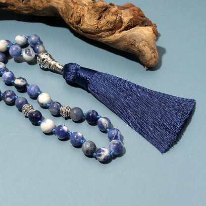 Zoomed image of Sodalite beads with driftwood in background