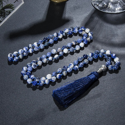 Lifestyle image of 99-bead Sodalite tasbih, folded and elegantly displayed

