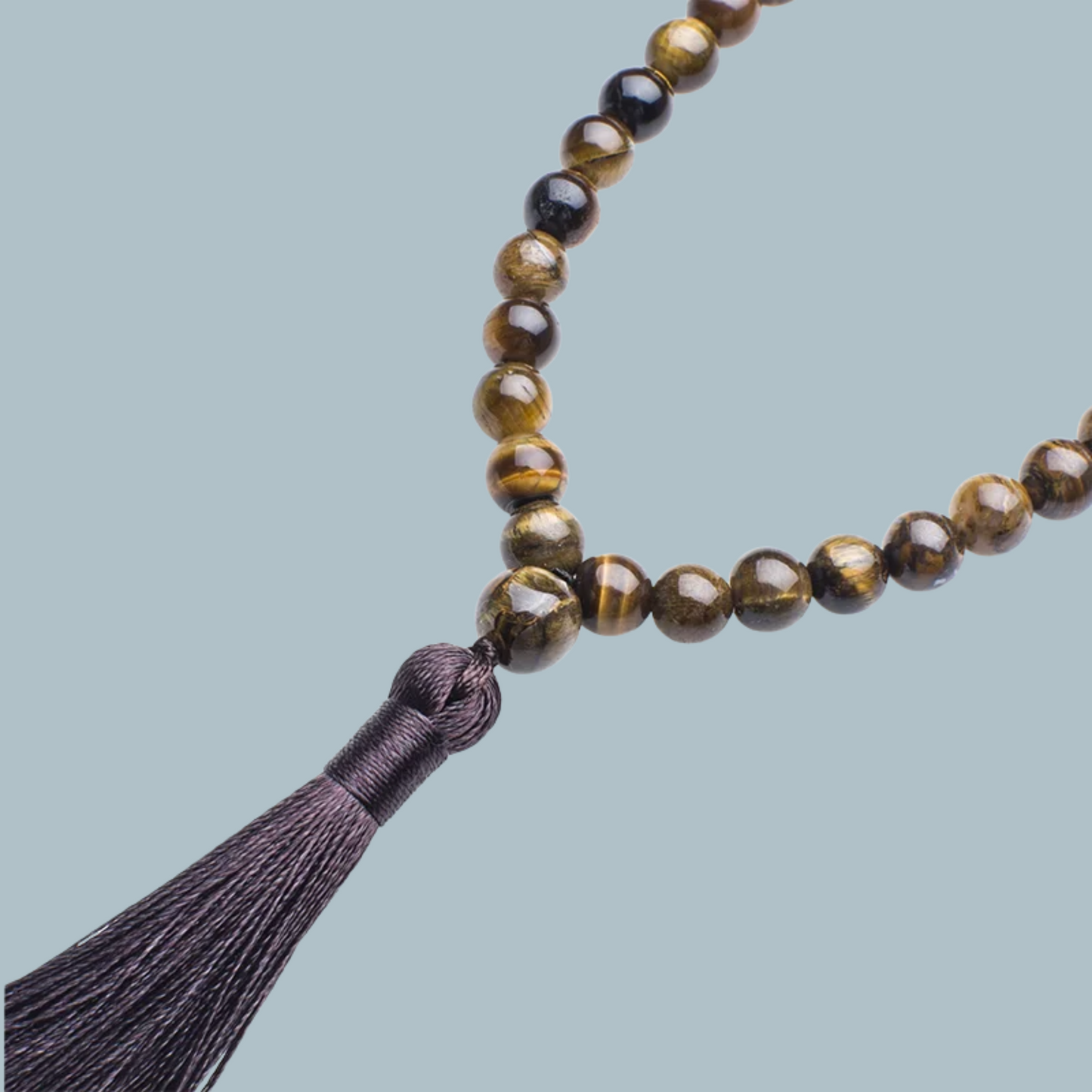 33-bead Tiger Eye tasbih with rich golden-brown tones on display