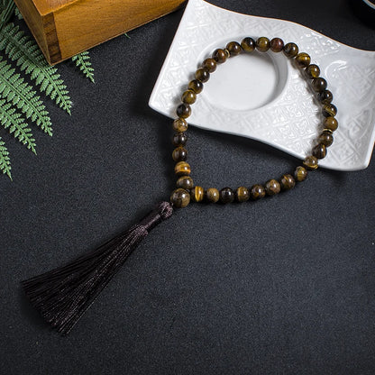 Full 33-bead Tiger Eye tasbih displayed in natural lifestyle setting