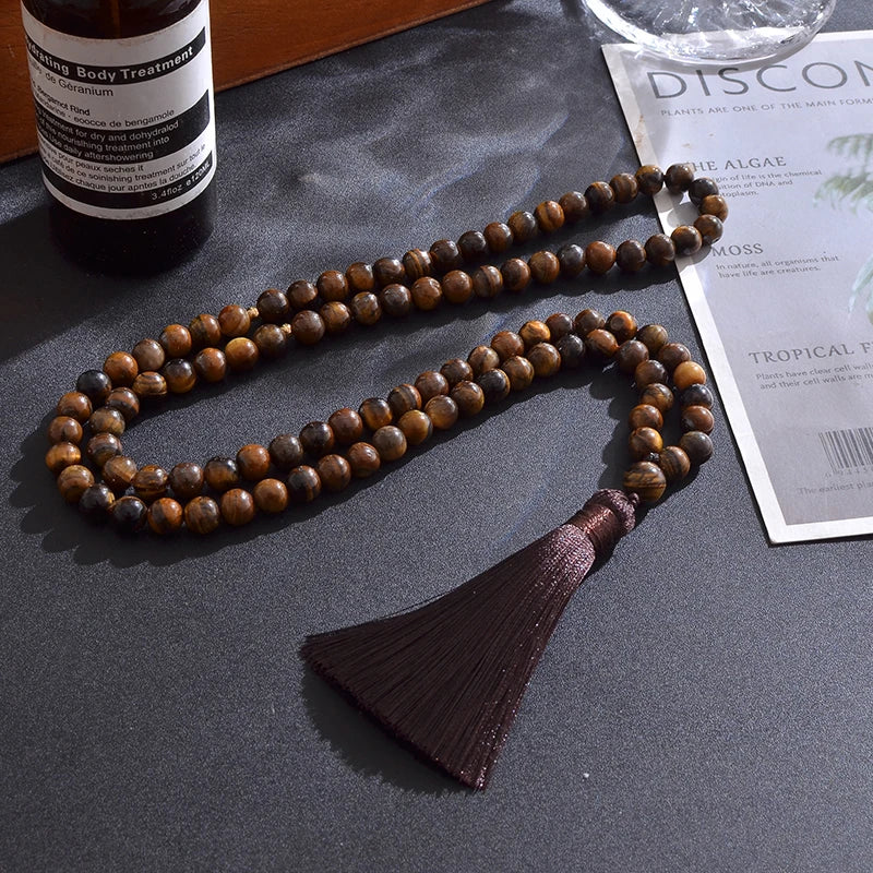Alternate lifestyle photo of 99-bead Tiger Eye tasbih arranged with earthy textures