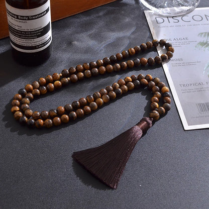 Alternate lifestyle photo of 99-bead Tiger Eye tasbih arranged with earthy textures